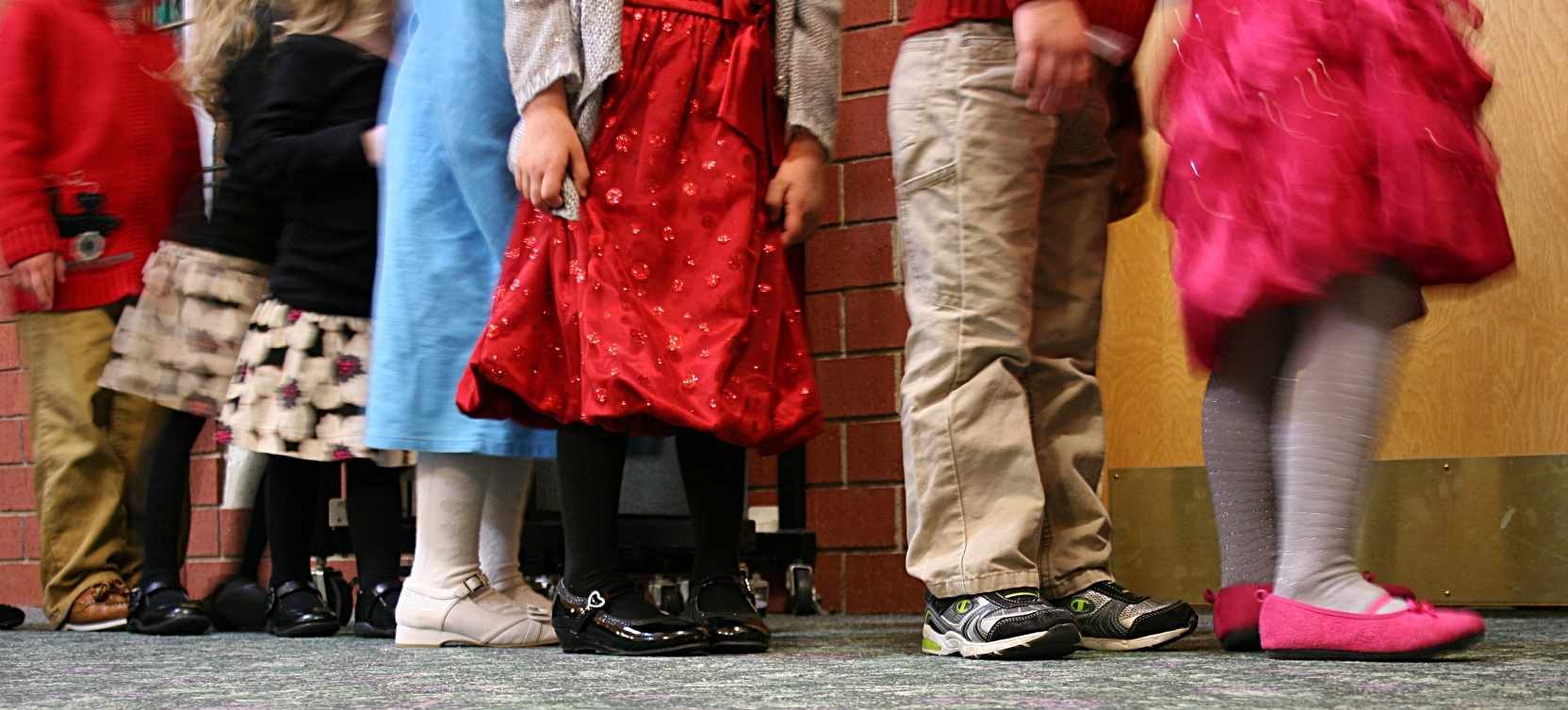 Dressed in holiday finery, the little ones wait in the fellowship hall before the start of the worship service.