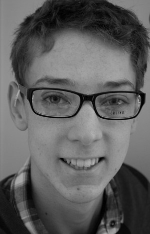 A current image of my son in the new eyeglasses he got over Christmas break. he brought home three frames to try for style and then his two sisters and I chose our favorite and we all picked this one. His oldest sister said the style fits his personality and makes him look smart. I agree and think they also age him, which is not a bad thing when you are almost 19 and do not want to look like you are still in high school. Note that these are the try-on frames, which explains the writing on the lens and the tag on the bow.