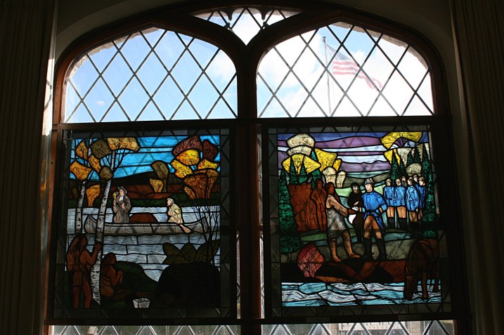 Windows depicting the region's early fur trading history.