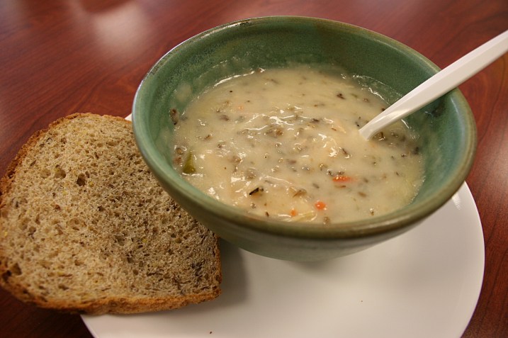 A soup server heated my soup in the microwave and then placed the hot bowl on a plate.