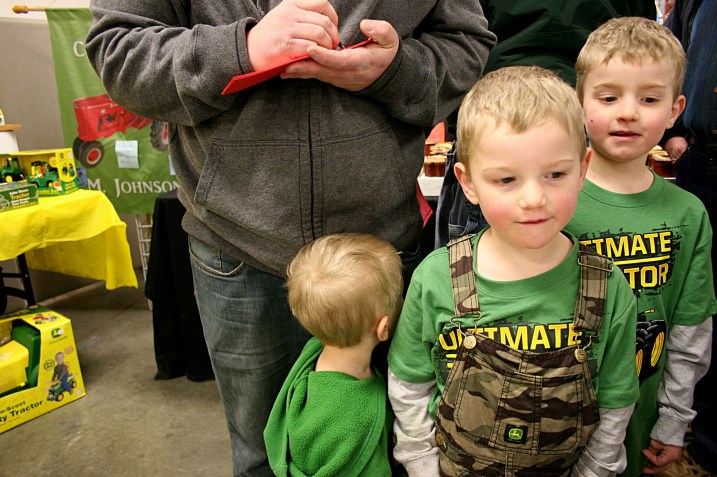 A trio of brothers dressed in John Deere attired waited while their dad signed up for a Massey Harris tractor raffle from Rice County Steam & Gas Engines, Inc.
