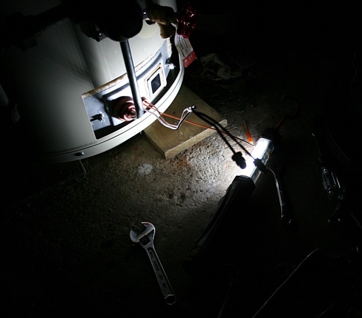 Tools and light are in place to replace the thermo couple control on the water heater.