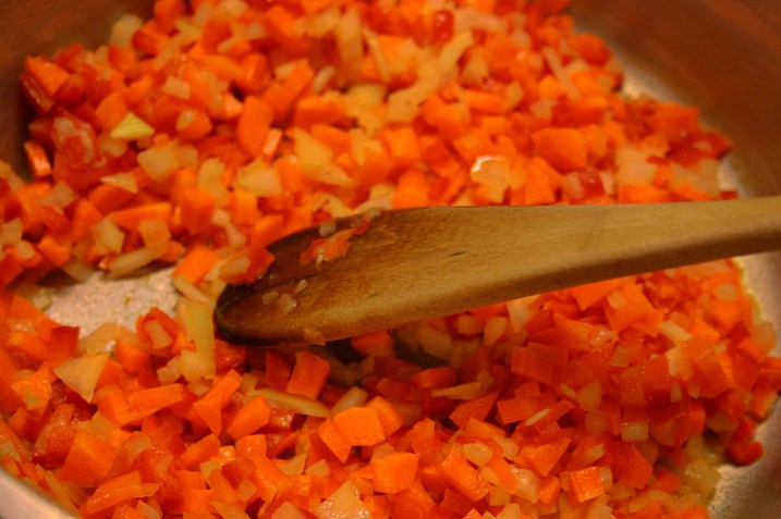 Sauteeing diced carrots, onion and red pepper.