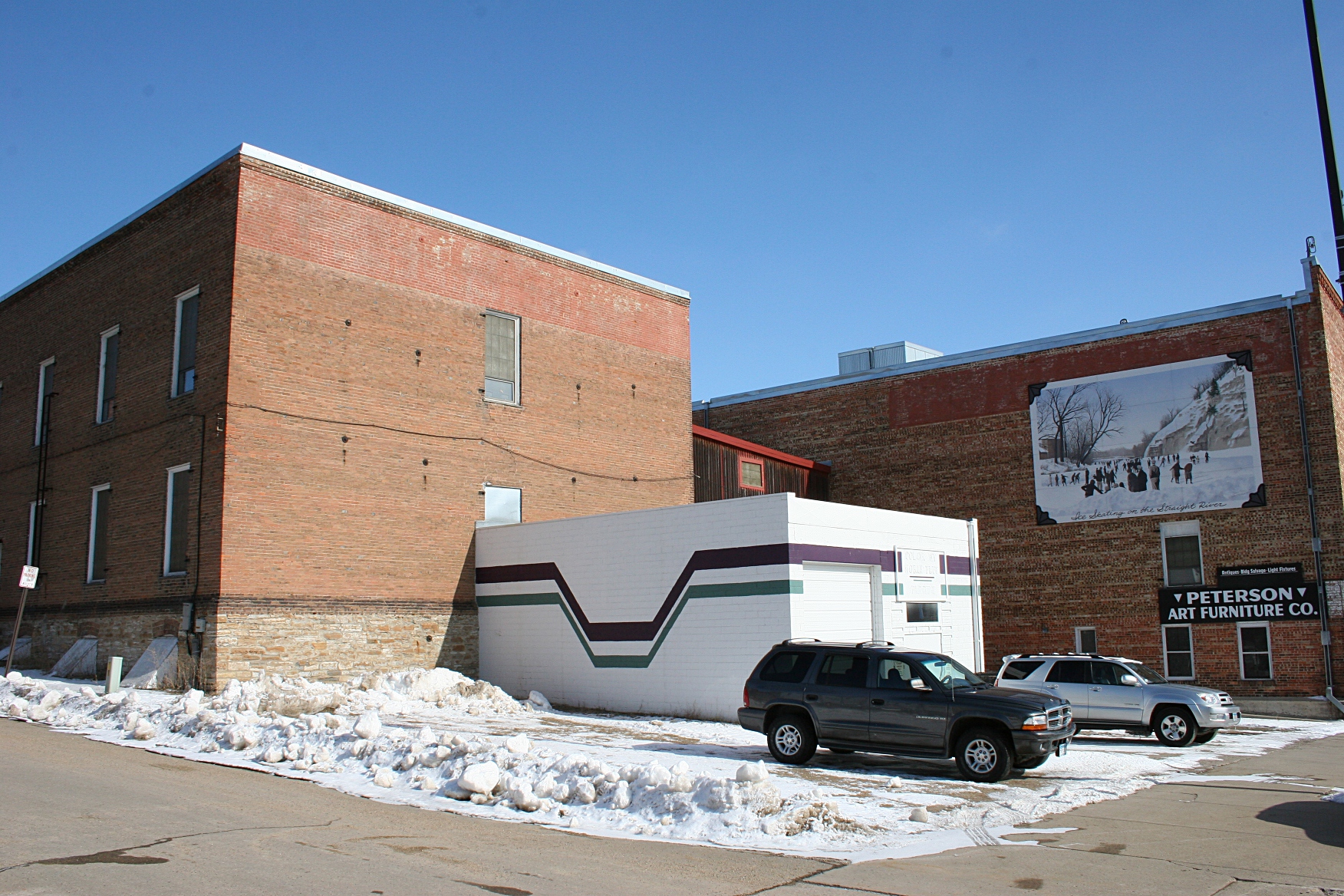 The brewery will be housed in the lower level of the brick building on the left with a tap room opening later in the small white building in the center of the Peterson Art Furniture complex.
