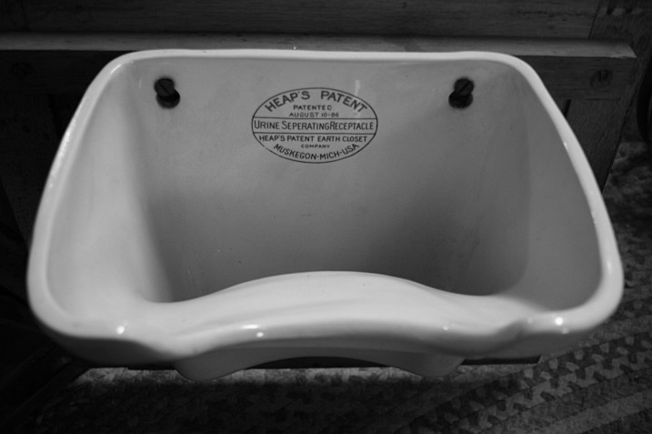 The urine collector which hangs on the door.