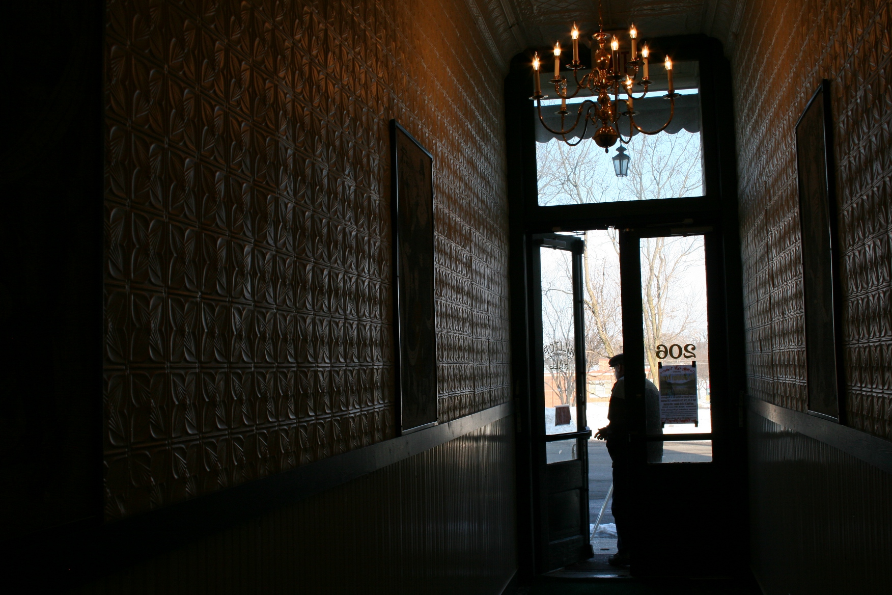 When Grimm purchased Hilltop Hall, site of a laundromat, he found 10 inches of lint covering these walls as dryers had been vented into the hallway. This hall runs between the heritage center and floral shop and leads to a stairway to the performance space.