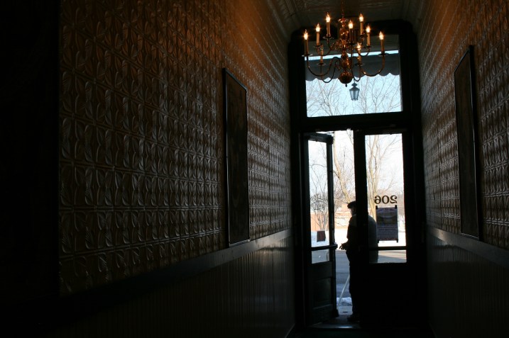 When Grimm purchased Hilltop Hall, site of a laundromat, he found 10 inches of lint covering these walls as dryers had been vented into the hallway. This hall runs between the heritage center and floral shop and leads to a stairway to the performance space.