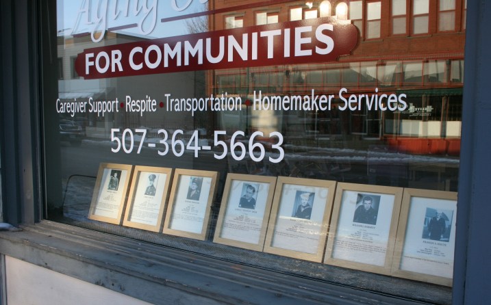 Veterans' photos and information in the window of Aging Services.