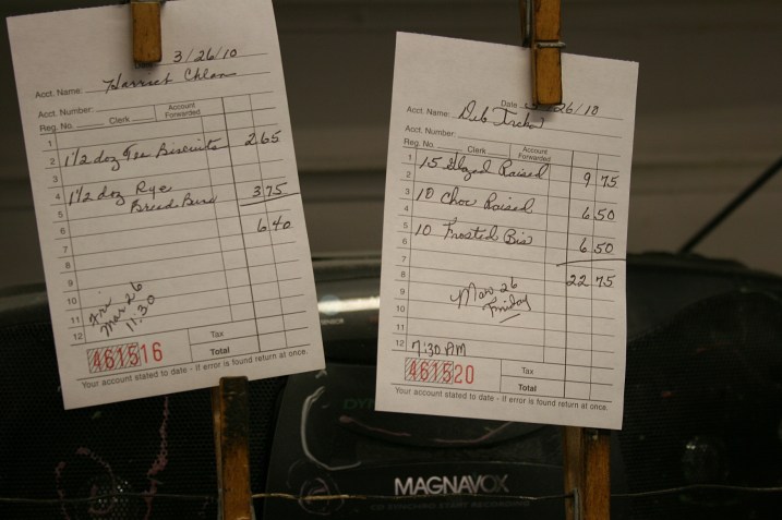 Customers orders hang in the kitchen.