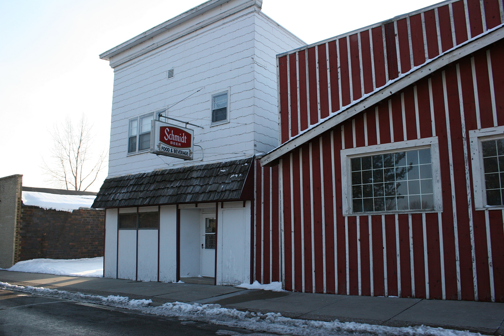 Because my eldest daughter is in love with a Schmidt boy (nothing to do with the beer), I had to photograph this sign. The striped building is the local meat market.