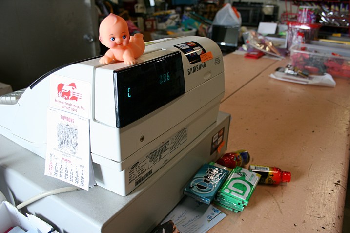 Look around and you'll see Bernadette's sense of humor in signage and props like this doll perched upon the cash register.