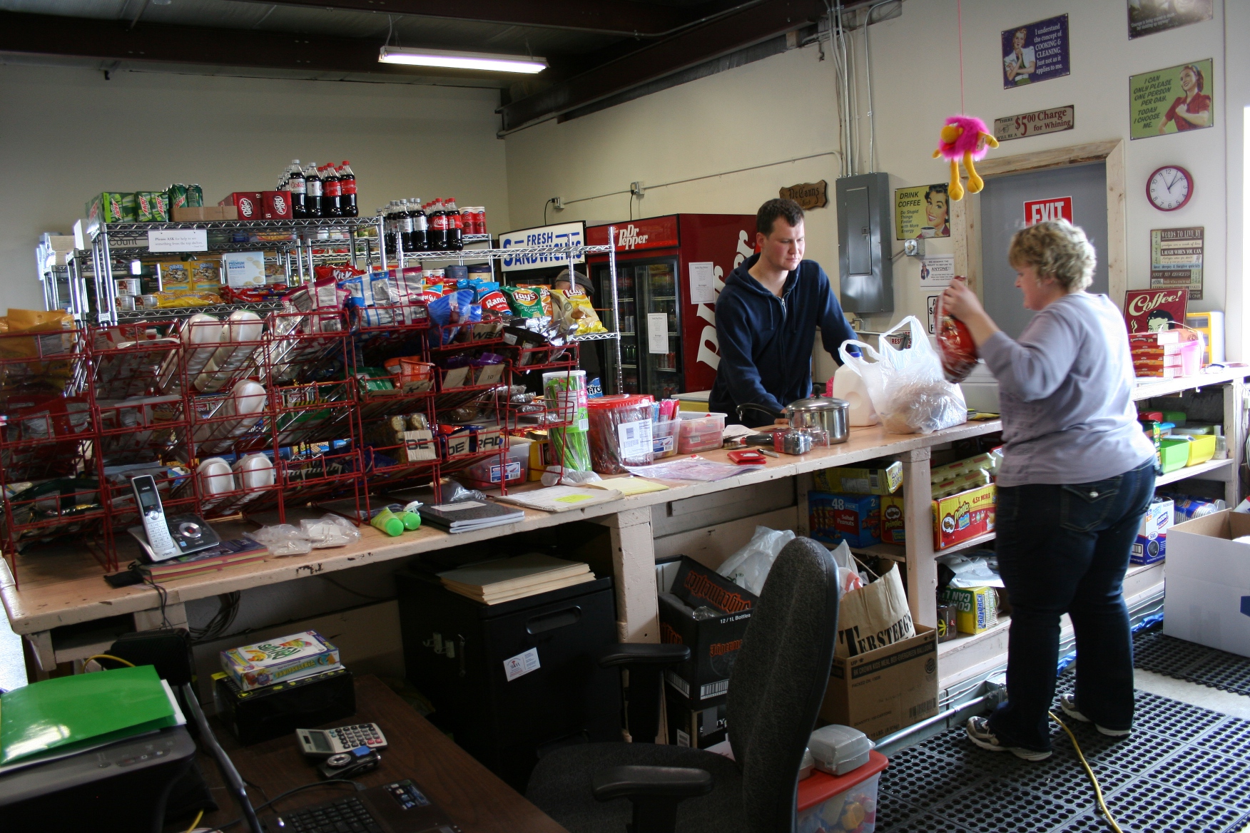 Just another view of the store with Bernadette bagging Jason's purchases.
