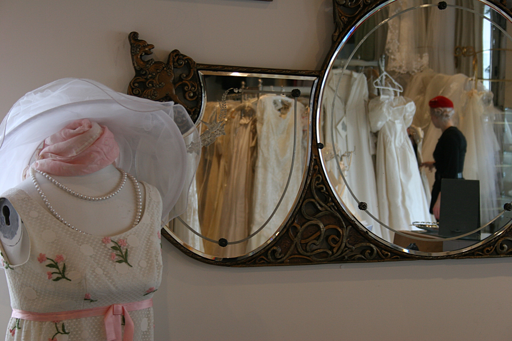 A sweet vintage dress, left, and Nikolina reflected in shop mirrors.