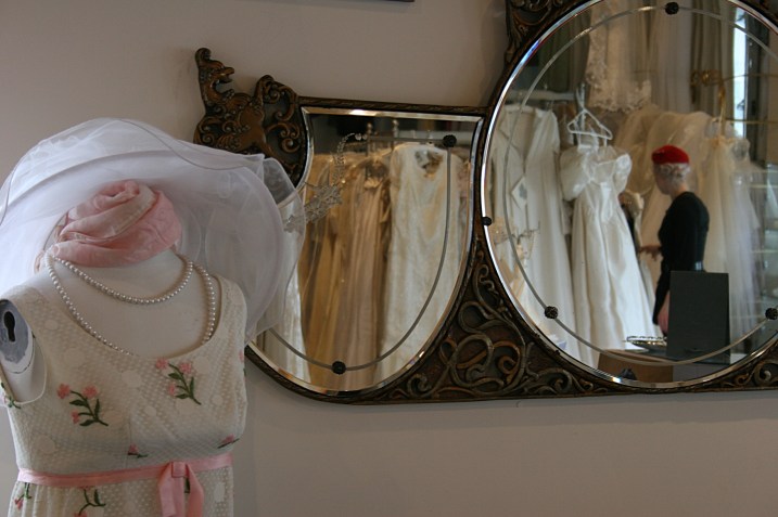 A sweet vintage dress, left, and Nikolina reflected in shop mirrors.