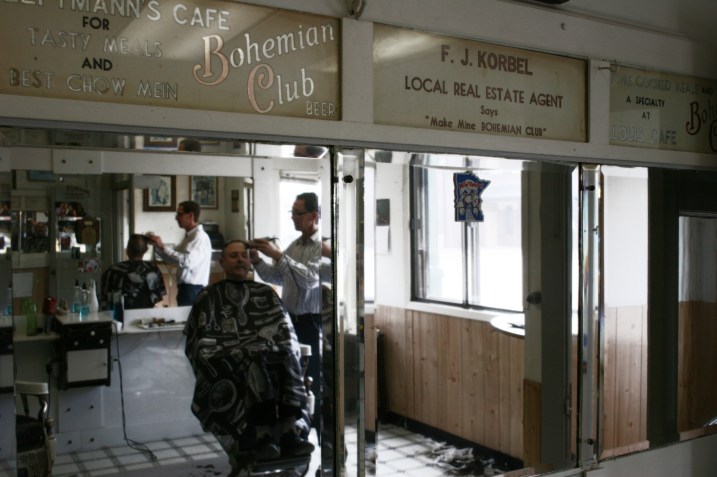 Above the bank of mirrors on the north side are vintage signs printed at Bohemian Club Beer.