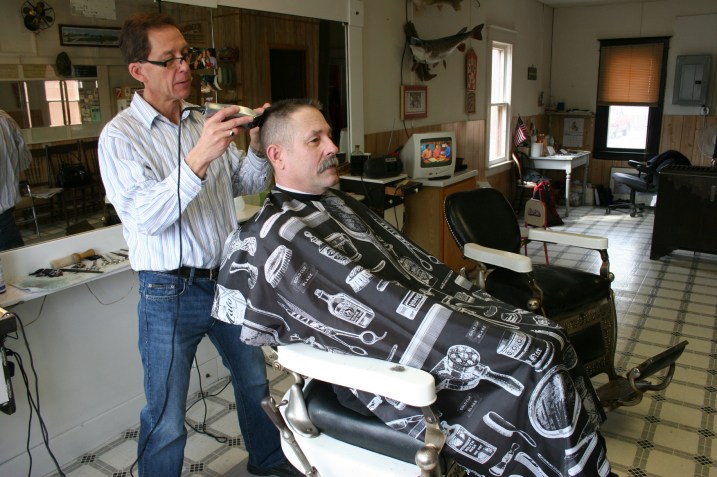 Steve works on Bill's flattop.