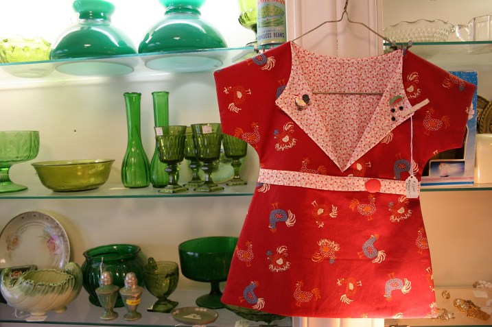 Vibrant handcrafted clothespin bags and glassware are among the merchandise offerings.