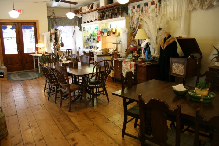 Shoppers can relax with a cup at a table and then buy the table and chairs if they wish. Note the beautiful wood floor, which is not original to the store. LaNette bought some pine planks at the lumberyard to recreate the vintage look.