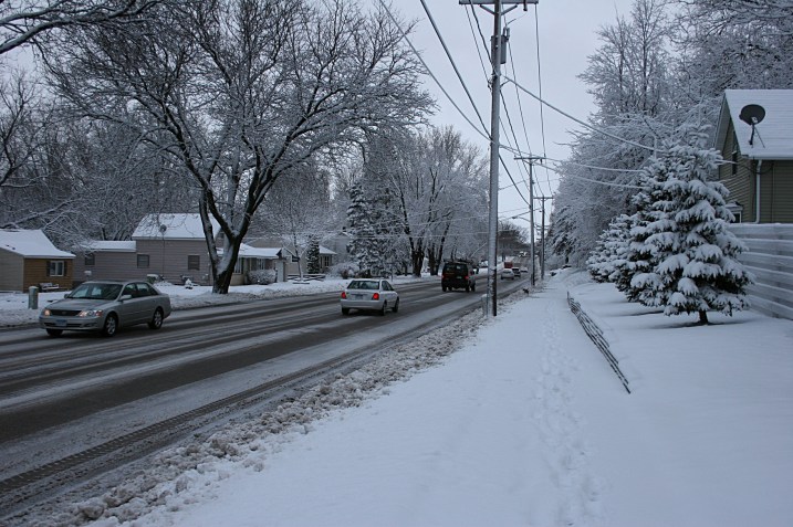 A portion of the  unshoveled sidewalk by my house, which I cleared of snow this morning.