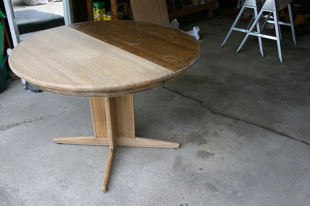 Compare the two table halves, the left side stripped and sanded, the right side top, not.