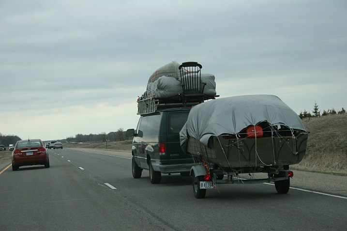 Just like The Beverly Hillbillies, a rocking chair is secured atop this van.