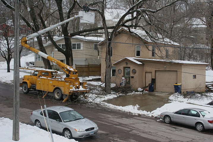 A tree service company arrived at my neighbor's house across the street this afternoon to remove dangling limbs. That's her car with the smashed windshield to the left in this photo. See my earlier photo of the car above when parked in her driveway. The limb fell onto her car at 6 a.m.