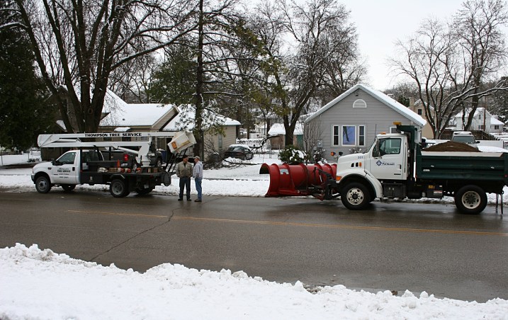 A City of Faribault snowplow driver and a Thompson Tree Service worker confer along Willow Street this morning.