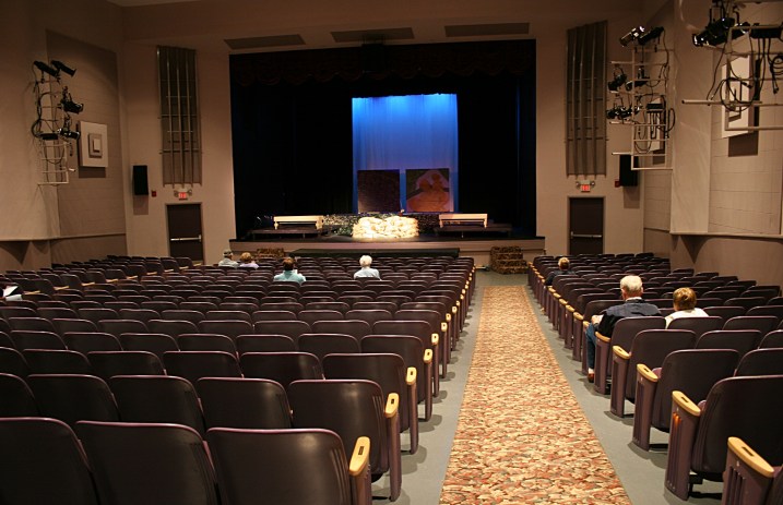 Audience members filter into an historic theatre for a play presented at a Center for the Arts.