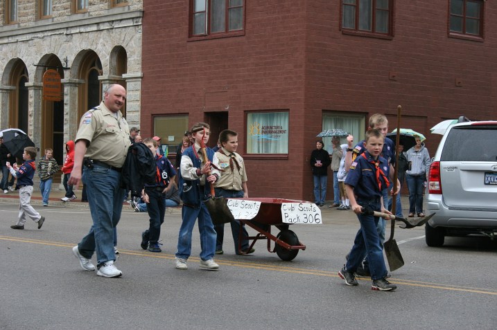 The Boy Scouts always follow to scoop up the horse poop.