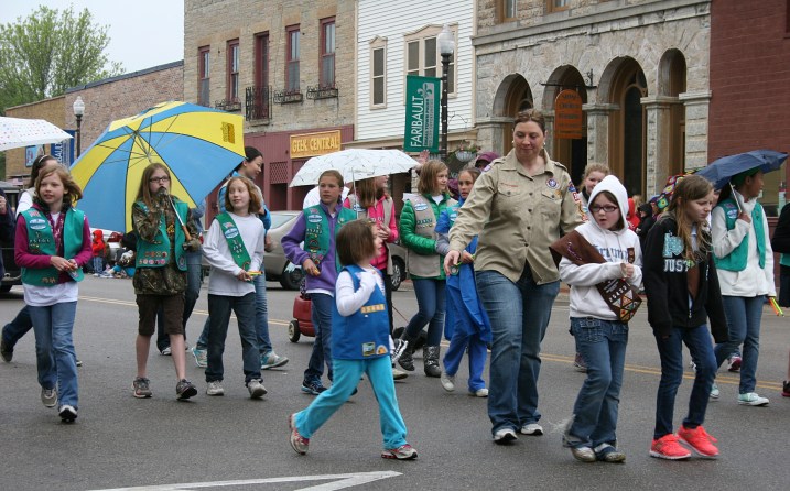 Girl Scouts walk in the rain at the end of the parade.