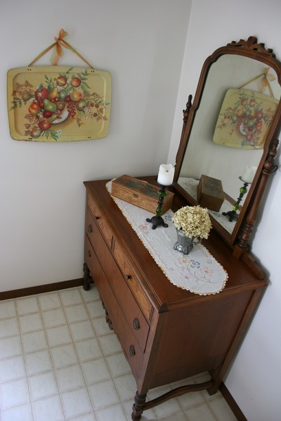 Here's the setting where the fruit tray hangs, next to a vintage family dresser which my husband refinished many years ago. The items on the dresser, with the exception of the candle holder, were purchased at the Faribault Salvation Army (teapot) and at a flea market (wooden box).