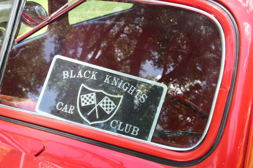 A car club advertised in a windshield.