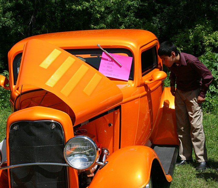 One of three young boys who walked down from a church up the hill to view the car show.