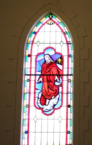 Stunning stained glass windows grace the sanctuary.
