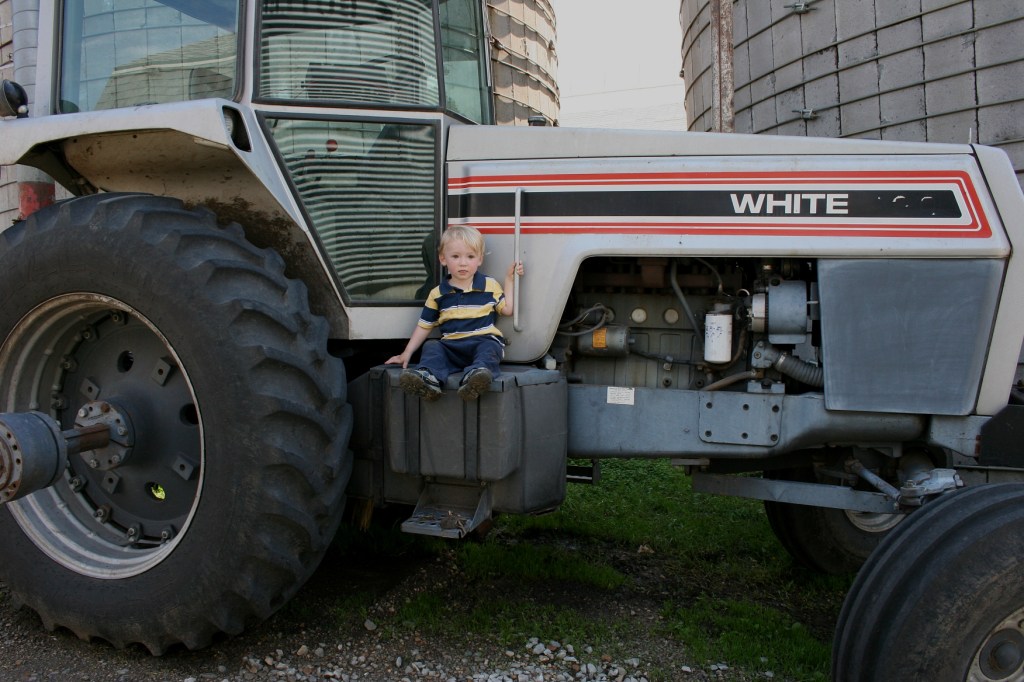 Benjamin, 2, lives on a buffalo farm near Lonsdale. His mom brought him to see a dairy farm. She was posing him for a photo on the tractor when I happened by.