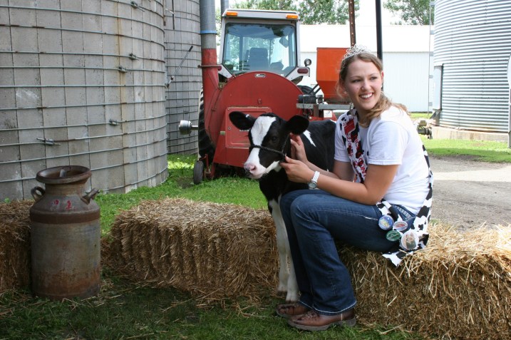 Rice County Dairy Princess Kaylee Wegner waits for kids to arrive for a photo with the calf.
