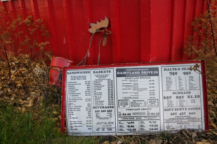 A vintage menu is propped outside the restaurant.