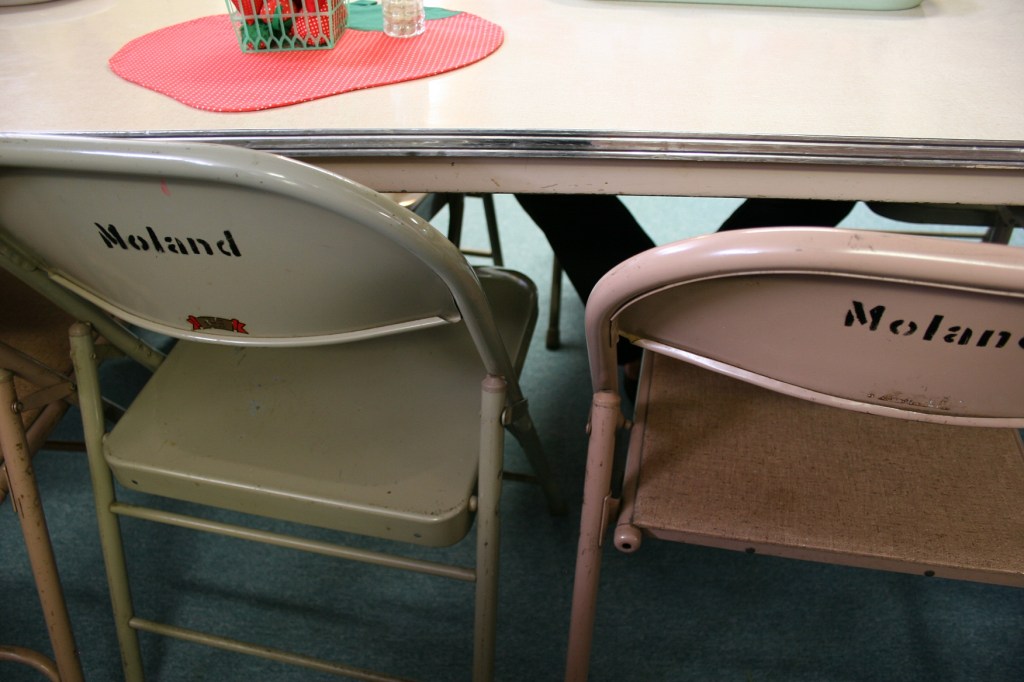 The backs of the folding chairs are labeled with the church name.