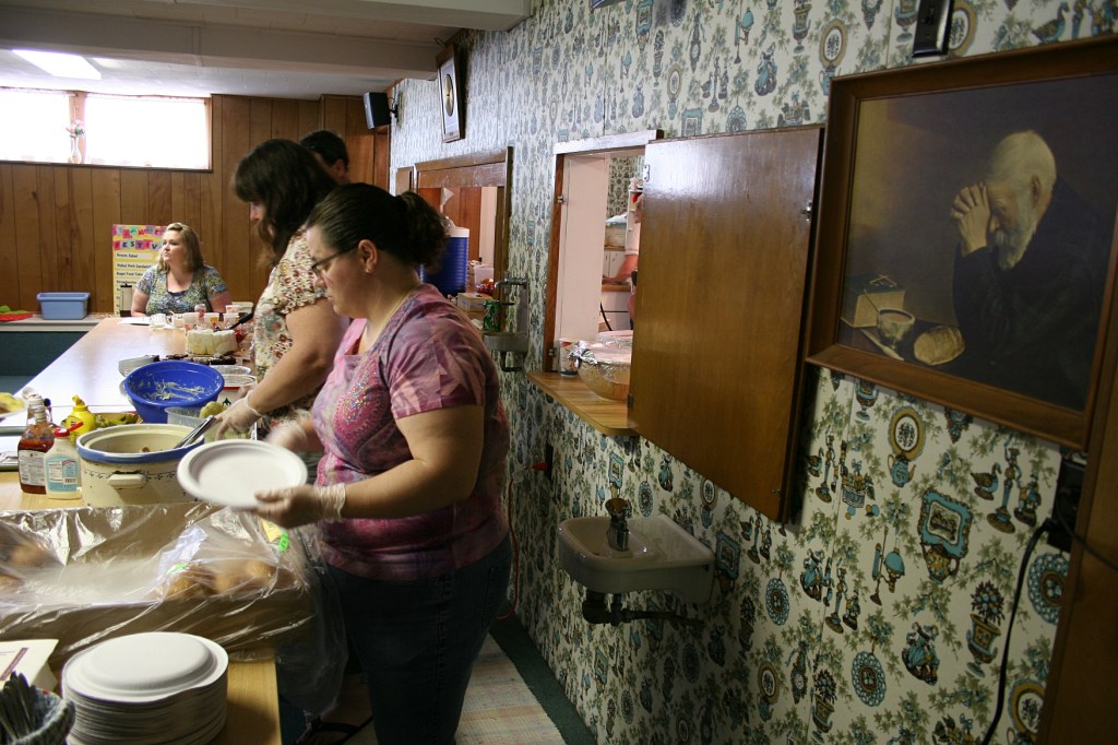 Volunteers dish up hot pork sandwiches from Nerstrand Meats, homemade potato salad, ice cream, angel food cake, strawberries and chocolate cake, whatever you choose.