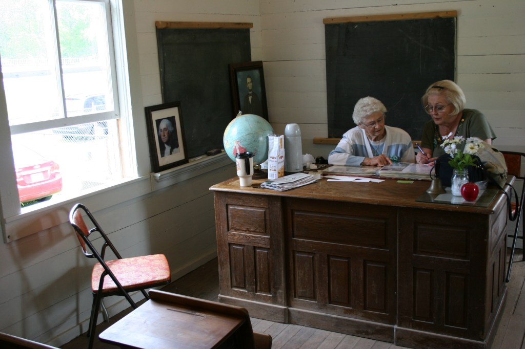 Helen Newman and Cindy Packard work on a sesquicentennial album.