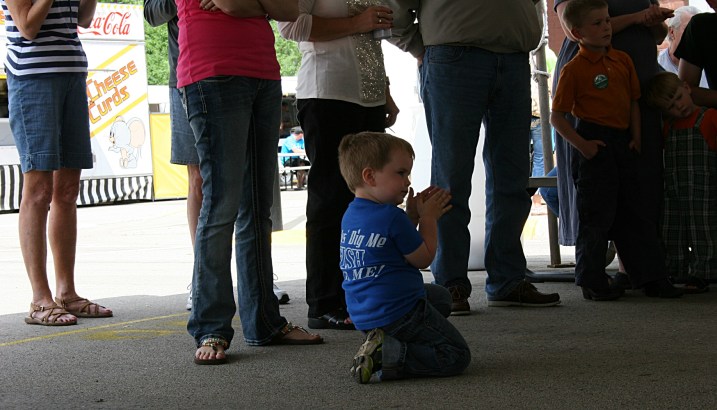 This little guy cheers on a competitor.