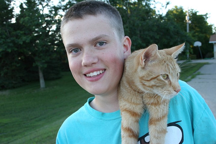 Ian, 14, with the family's cat,