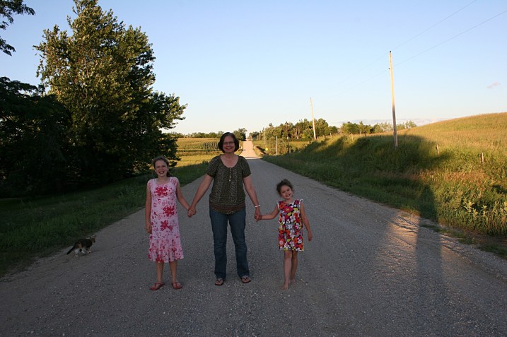 Standing on the state line road with Katie, left, and Lucy.