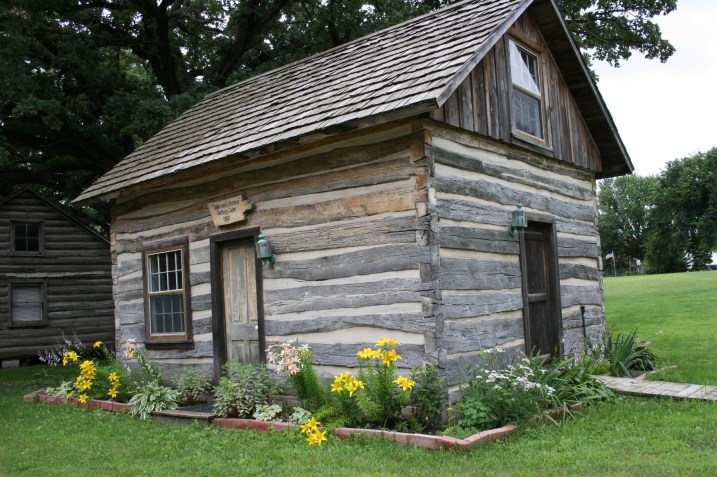 Log cabins on the fairgrounds include this one from 1860 and a replica of an 1839 cabin.