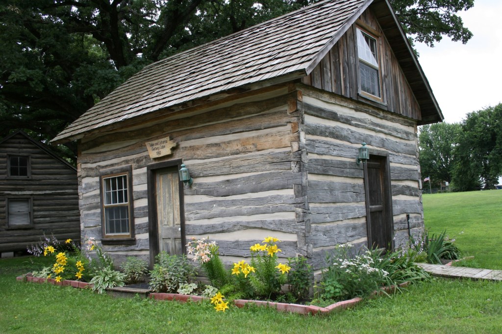Log cabins on the fairgrounds include this one from 1860 and a replica of an 1839 cabin.