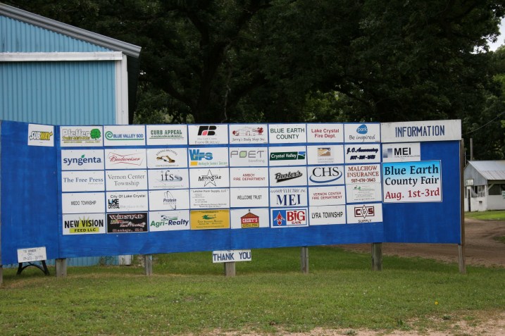  A posting of fair sponsors just inside the front gate.