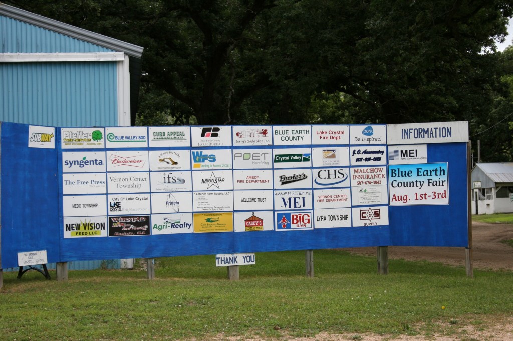 A posting of fair sponsors just inside the front gate.