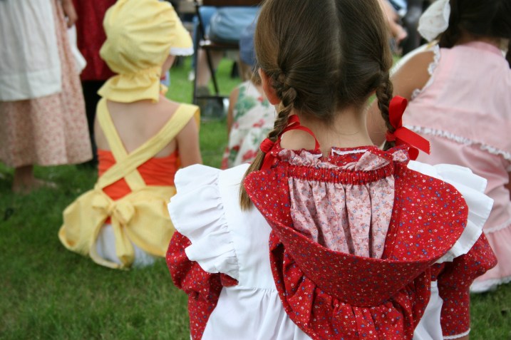 Pioneer prairie attire is the dress code of the day for all ages.
