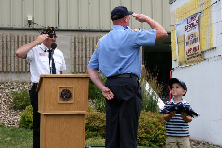 Carter accepts the flag for his military family.