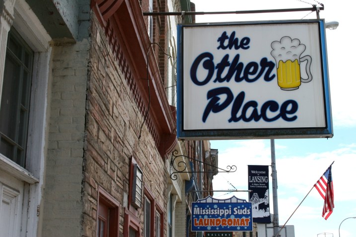 Signs and a flag in Lansing, Iowa.